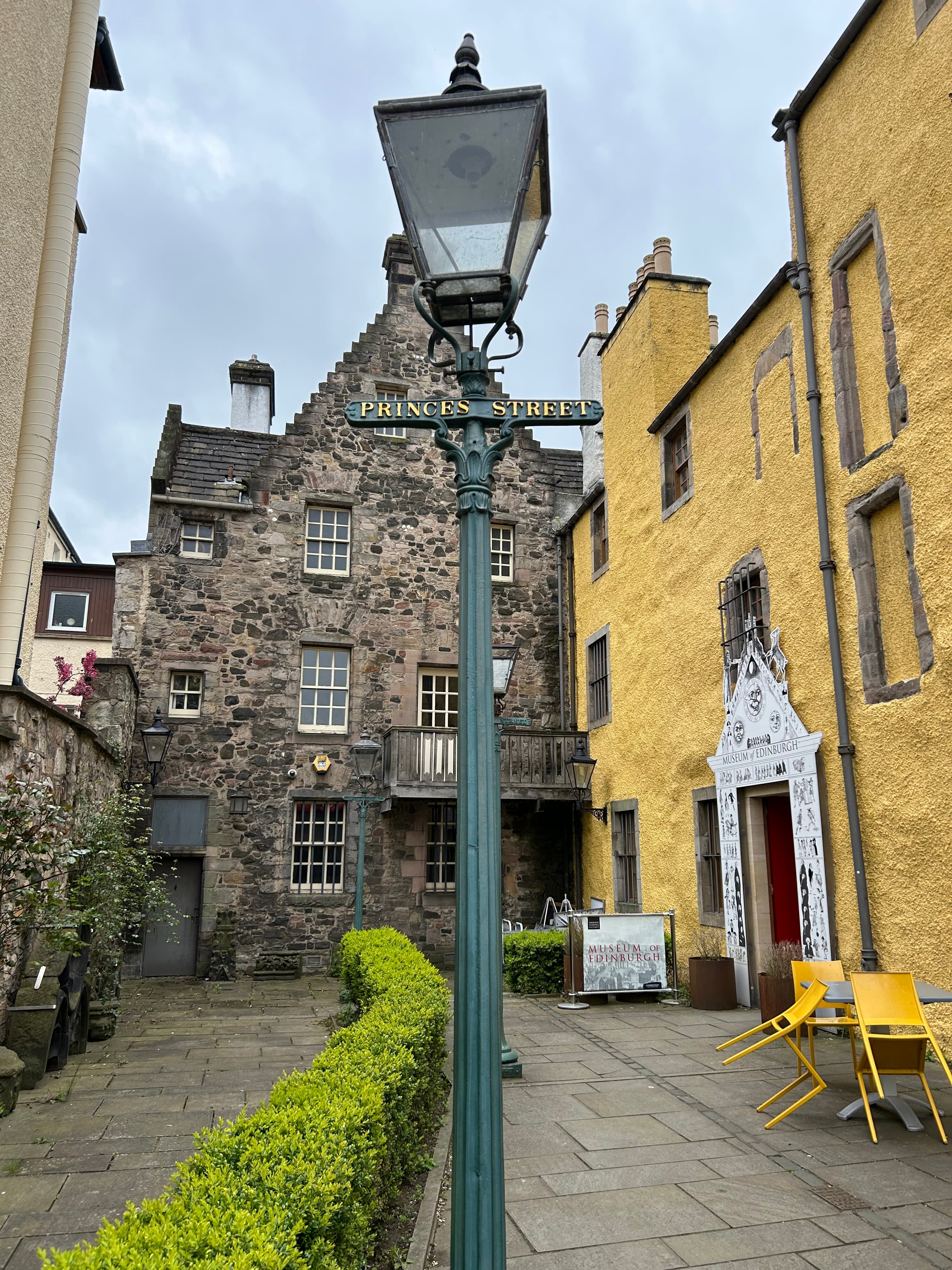 View of small street with old stone and yellow buildings in Edinburgh, Scotland