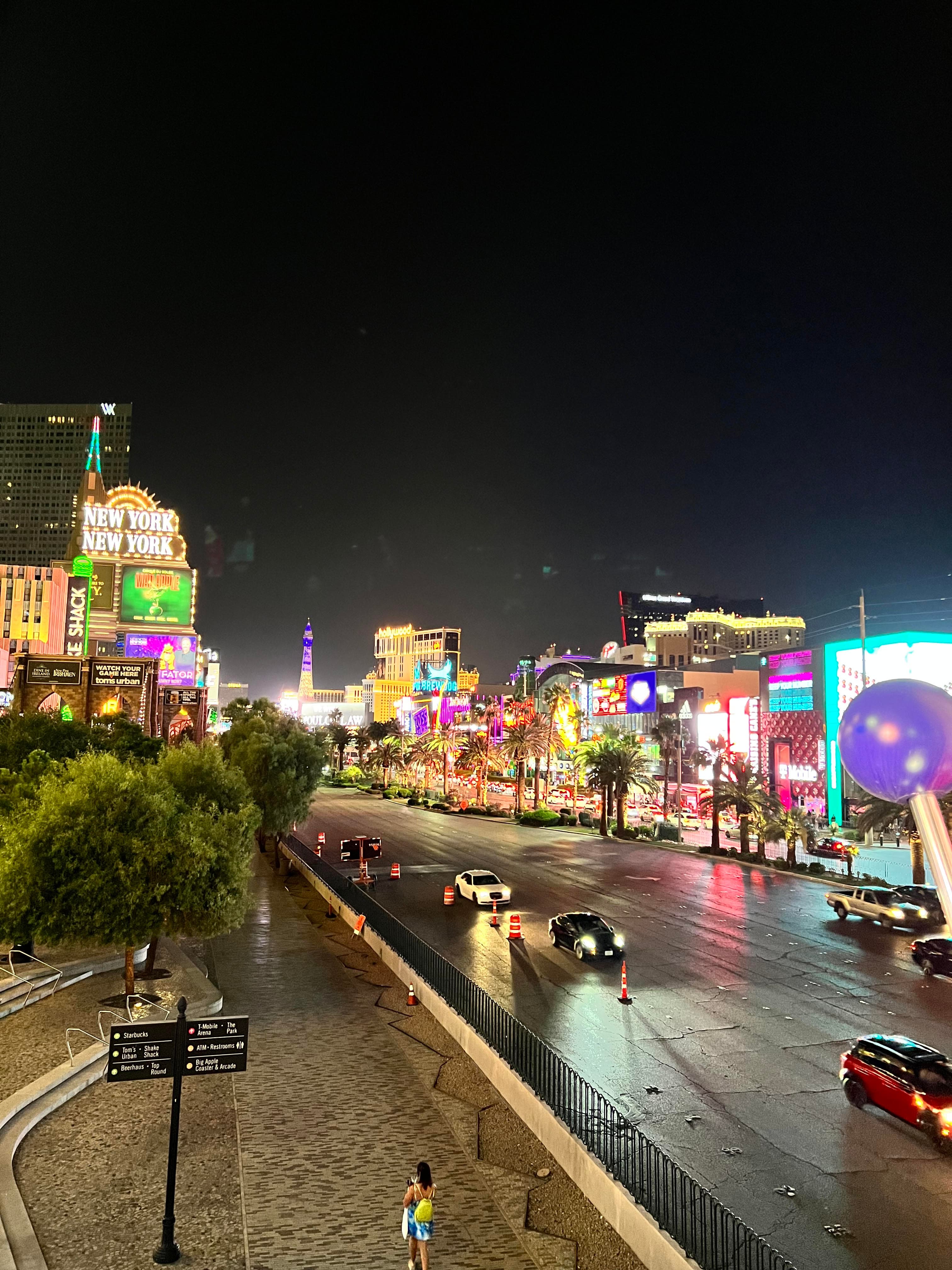 View of illuminated Las Vegas strip at night with brighly lit buildings and cars driving