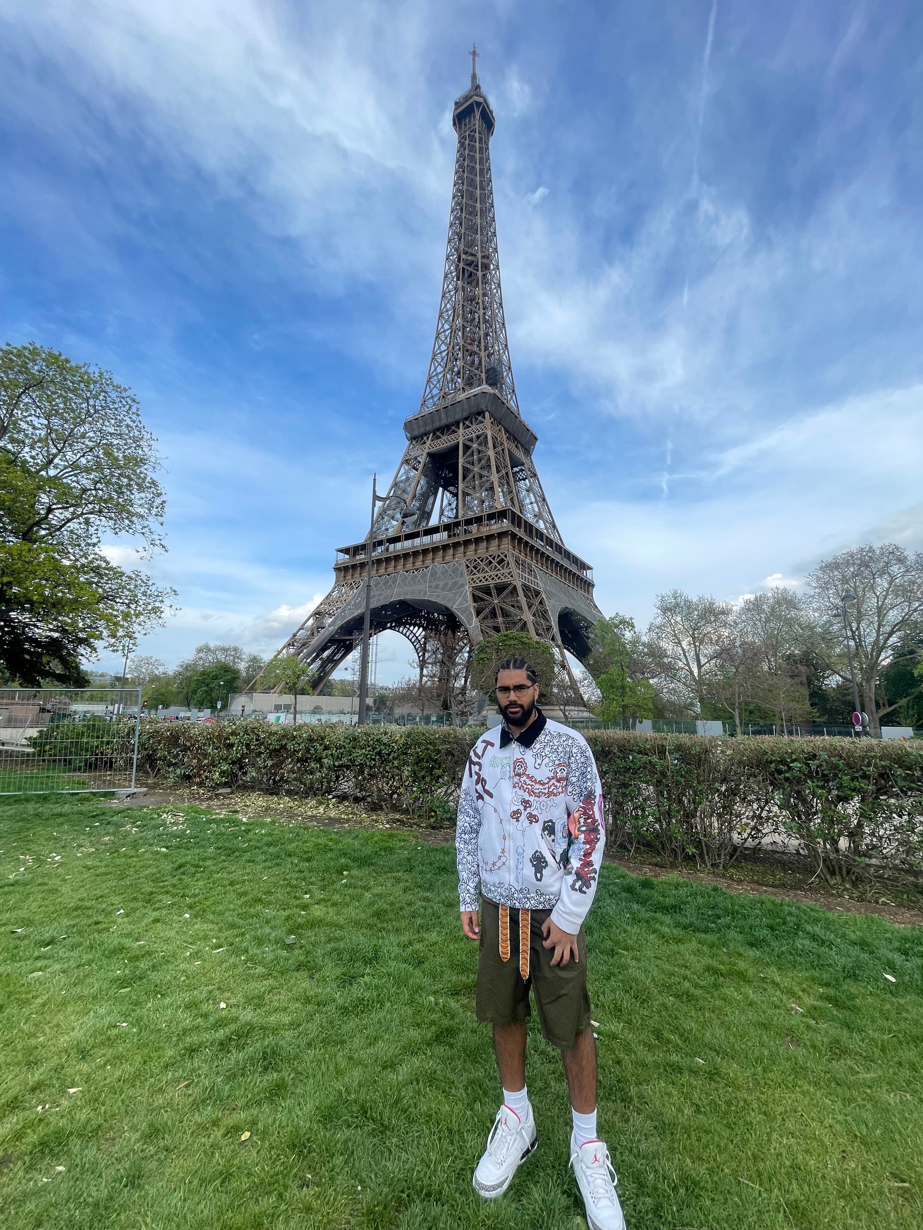 Travel advisor Matthew standing on grass with the Eiffel Tower in view