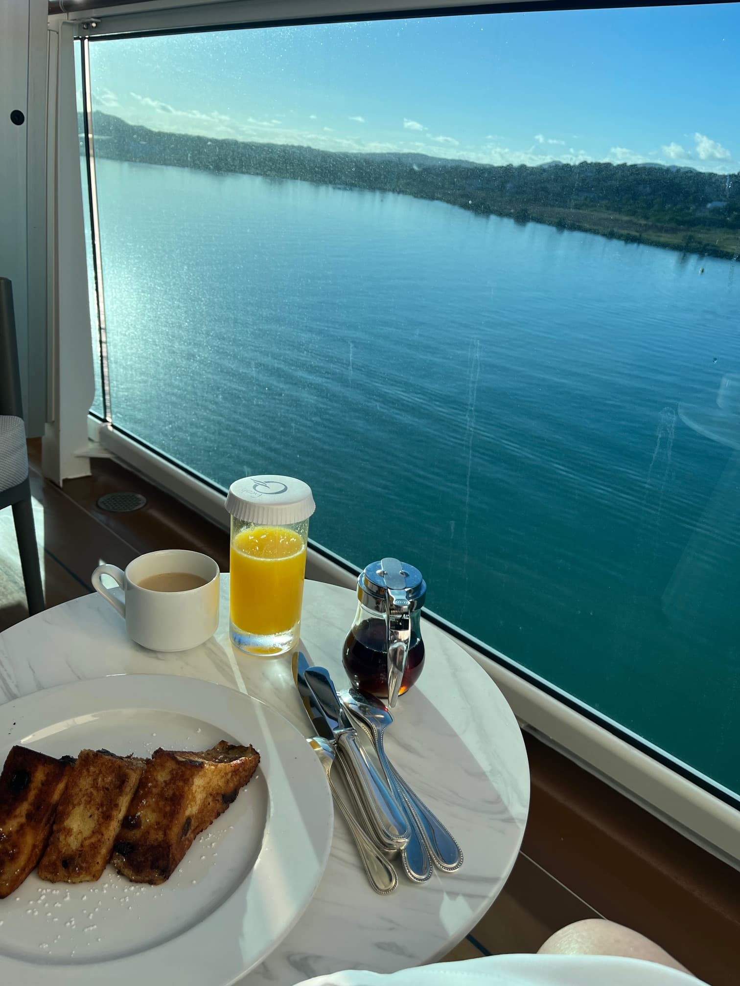 Dining setup by a window on a boat