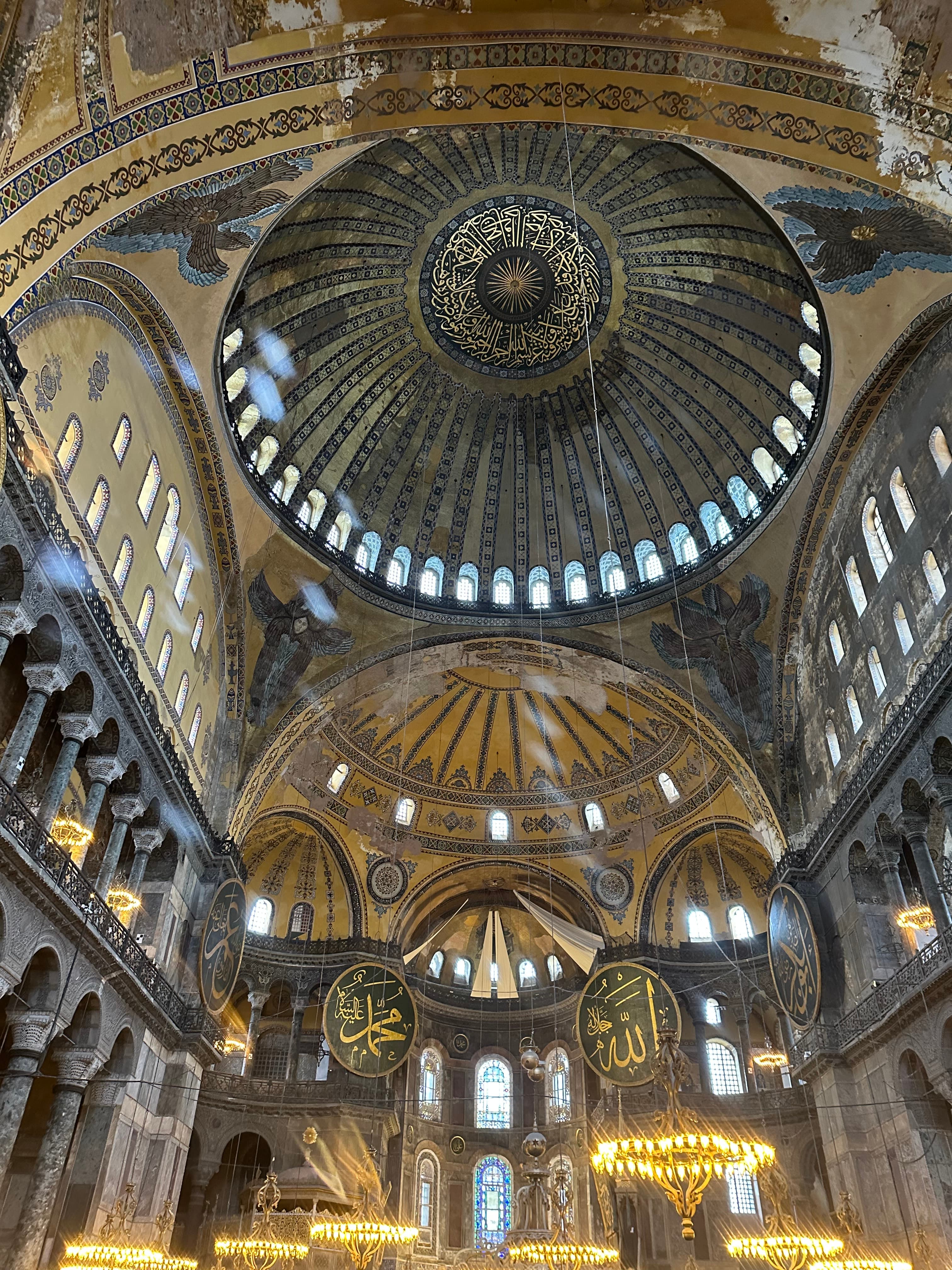 A beautiful view of the inside of dome church with an ornate ceiling and gold accents.