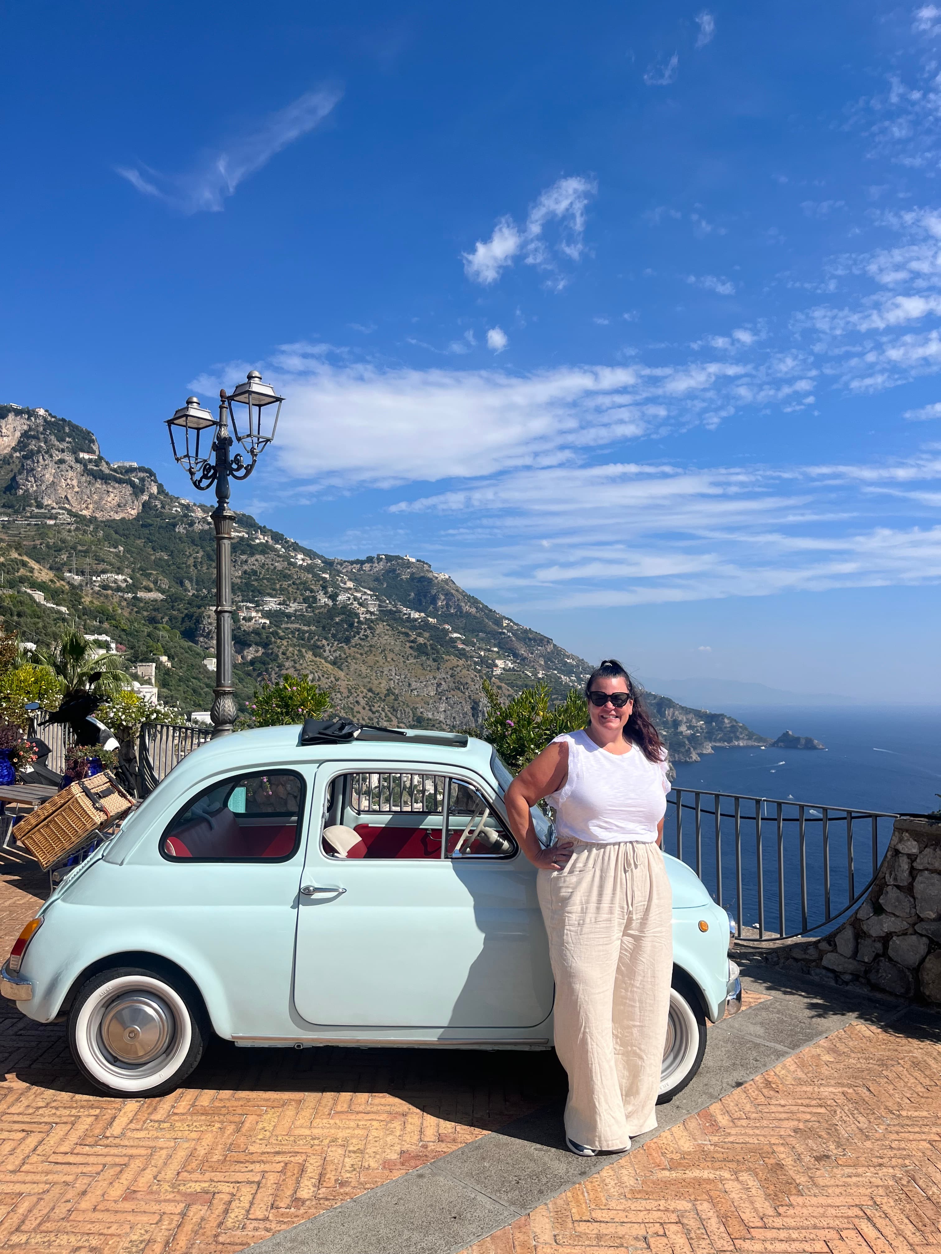 Posing for a picture with a mini car