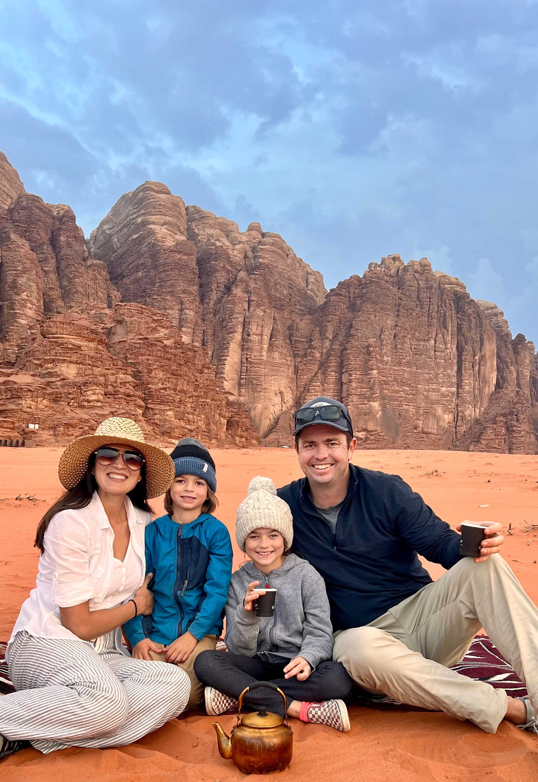 Nadiah posing with her family and the desert in the background.