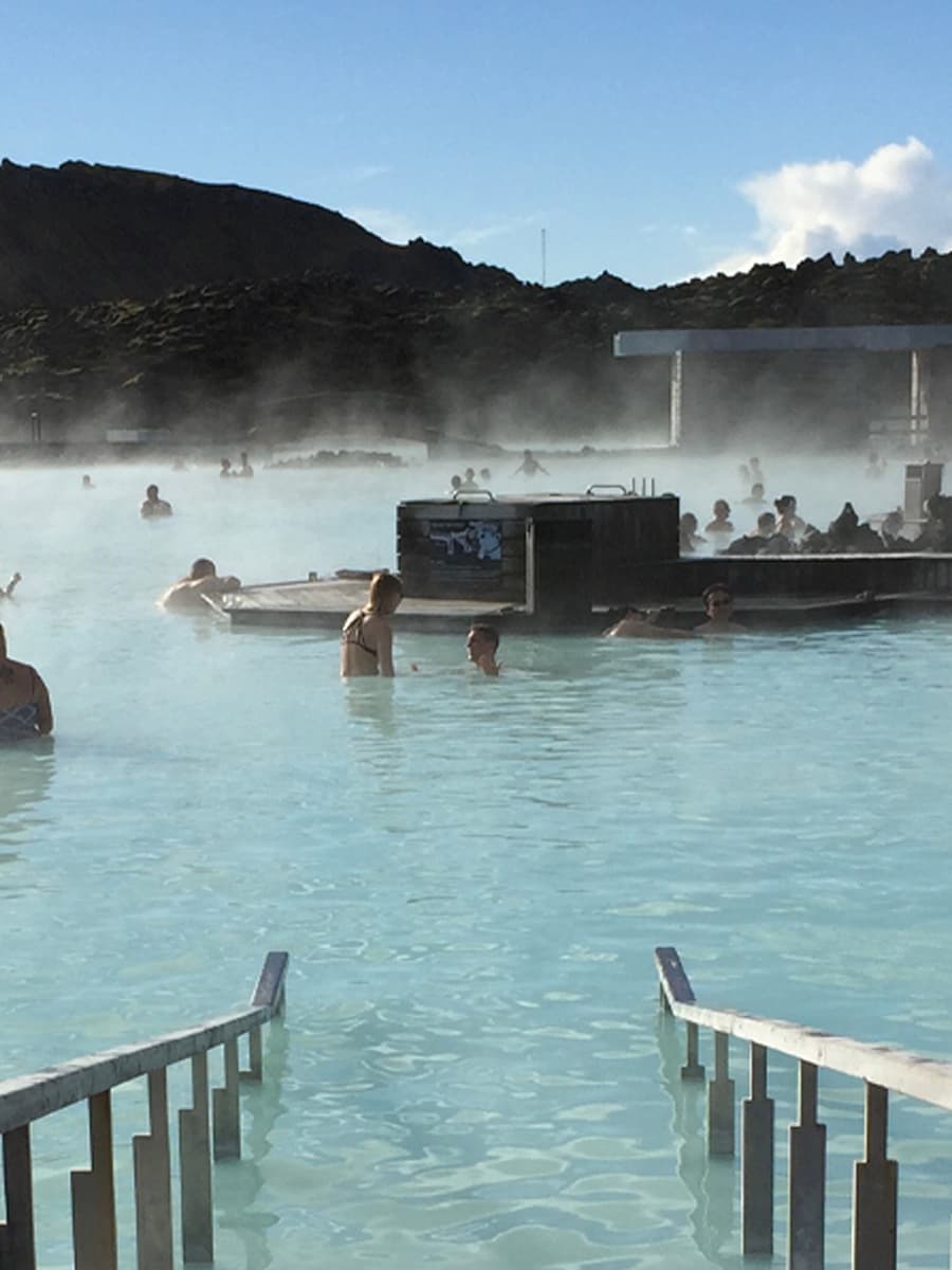 People in a large blue hot spring