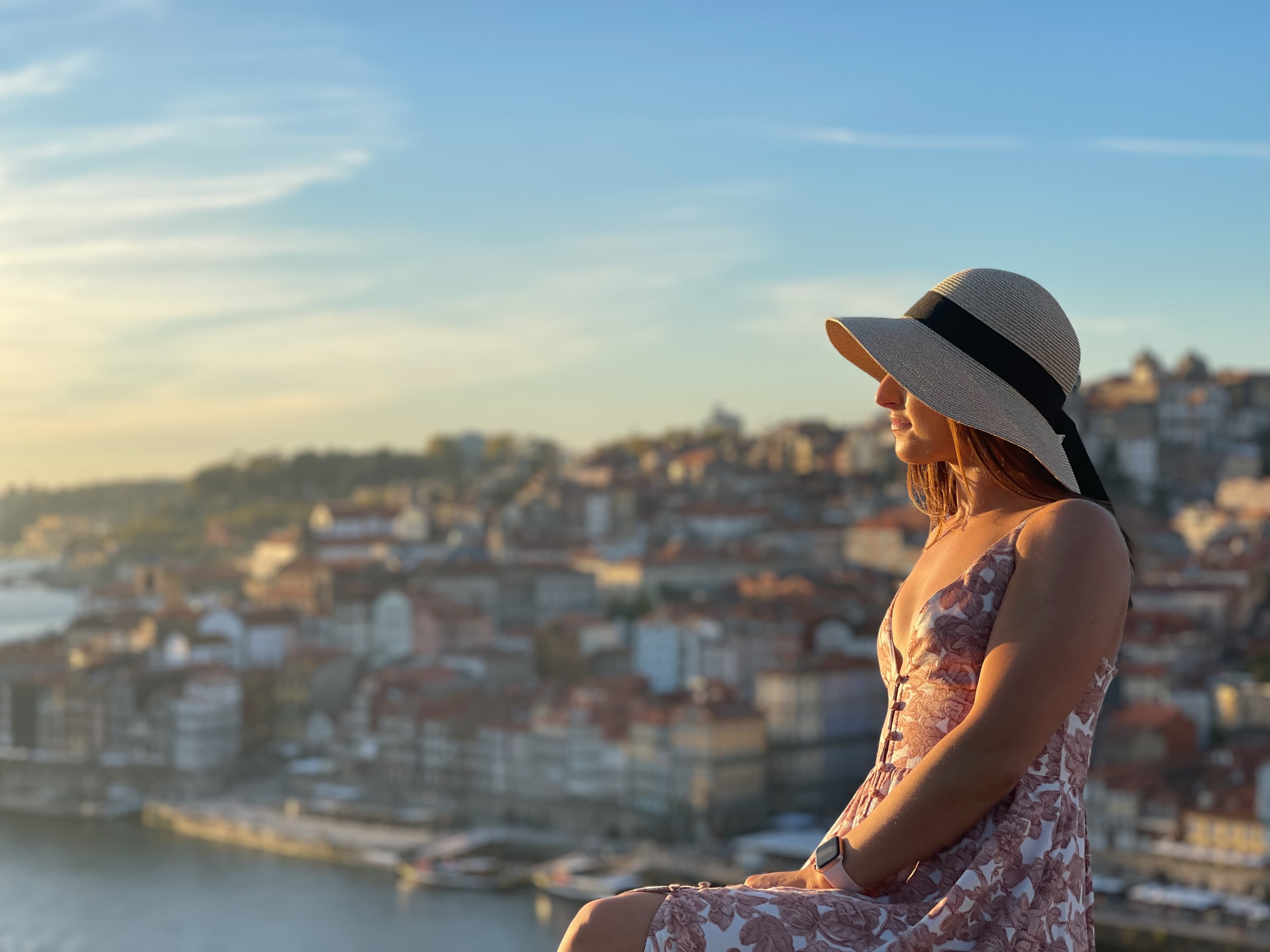 Posing for a photo in a floral print dress and a hat