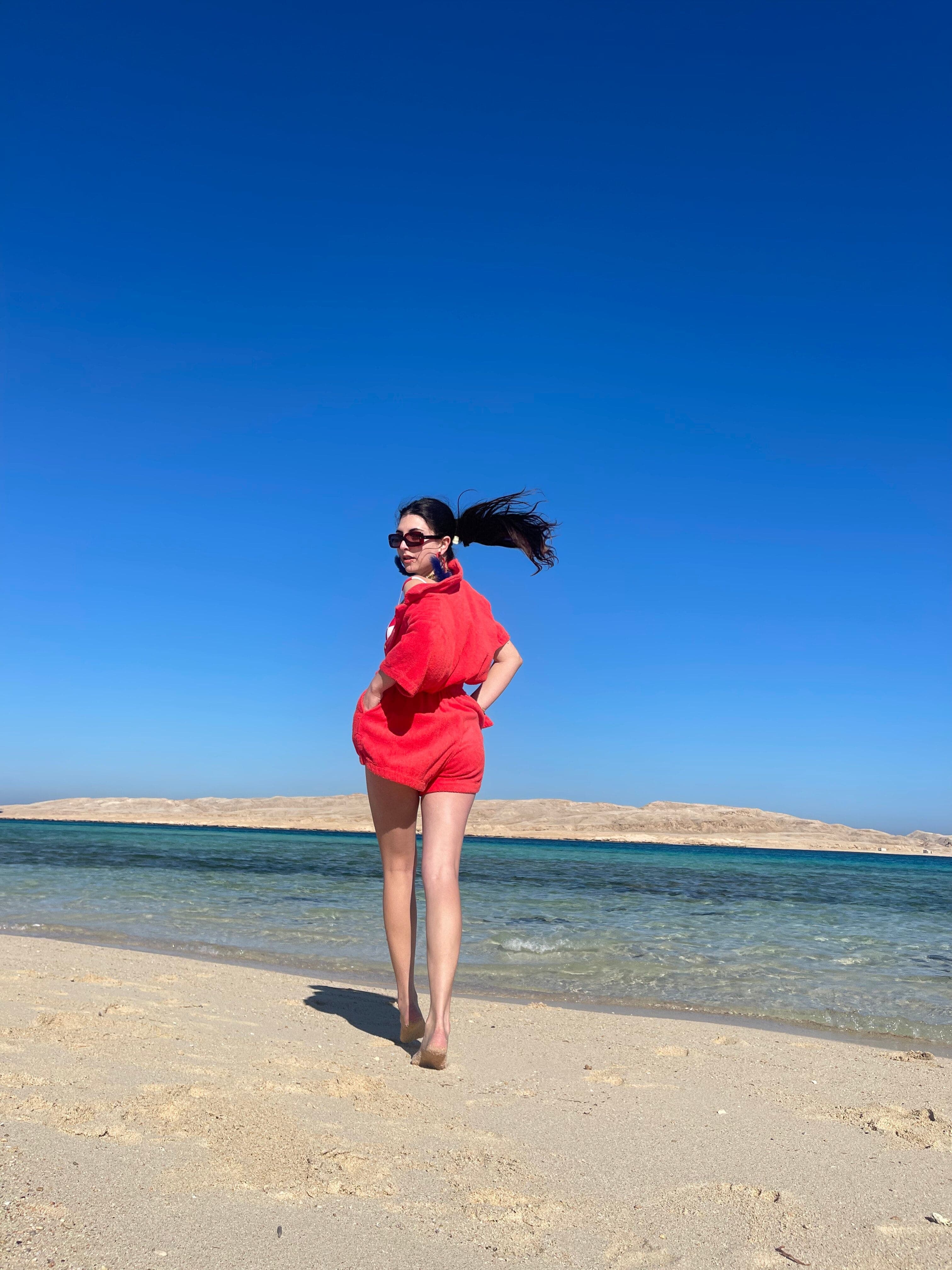 Picture of Gabrielle in red dress at beach